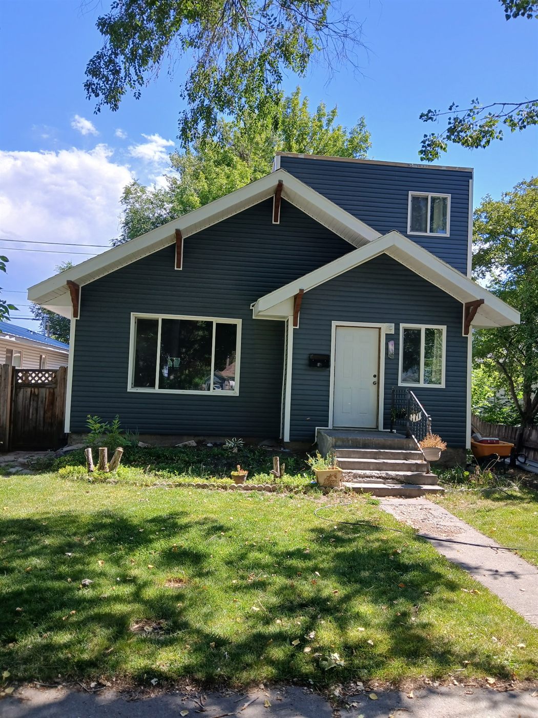 New charcoal-blue lap siding installed on a two-story home